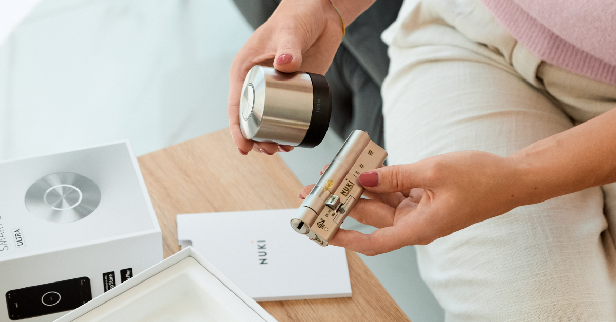 Woman holding Smart Lock Ultra and Universal Cylinder in hands